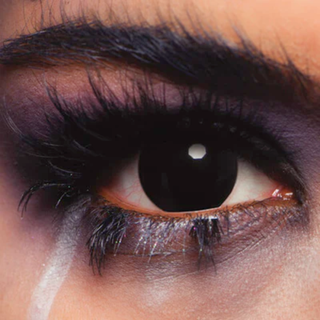Close-up of eye wearing Blackout Halloween Contact Lenses for a dramatic, soulless look.