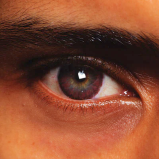 Close-up of eye wearing Chocolate Chai Natural Effect Contact Lenses for a warm, enchanting look, ideal for costumes or a night out.