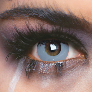 Close-up of eye wearing Zombie Grey Halloween Contact Lenses for a spooky undead look.