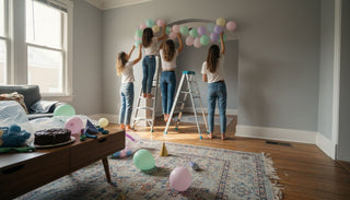 Friends setting up balloon garland for party
