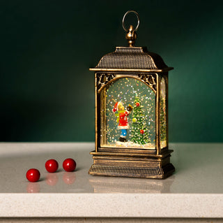 Christmas snow globe tree ornament with LED lantern scene, featuring hand-painted details and festive design.