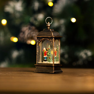 Christmas snow globe tree ornament with LED lantern scene and hand-painted details, creating a festive holiday atmosphere.