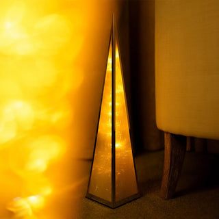 Christmas Pyramid LED Lights in gold creating a warm festive glow in a living room decor.