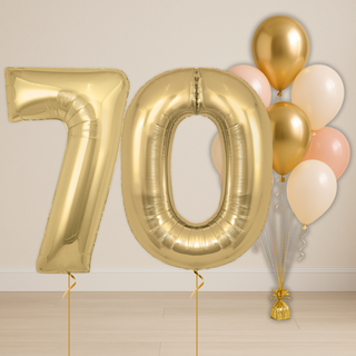 Baby pink & neutral balloon bouquet with gold number balloons for milestone celebrations.