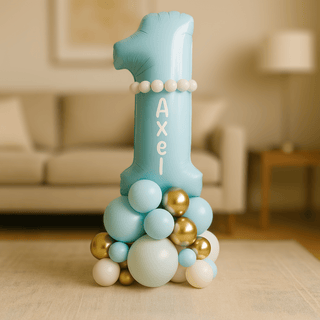 Personalised 1st Birthday Balloon Stack with name Axel on a blue number 1 balloon centerpiece in living room.
