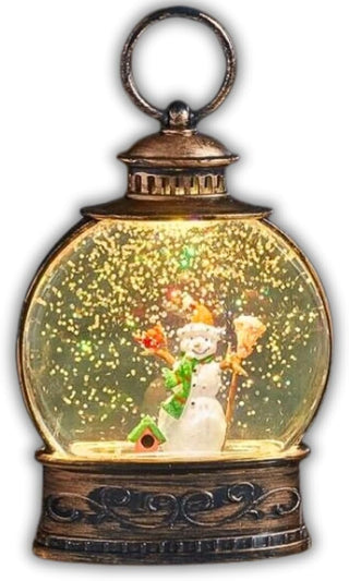 Christmas Snow Globe Ornament with LED lantern and snowman scene, featuring swirling glitter and festive charm.