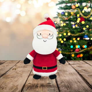 8Inch Santa Soft Toy in red suit by Christmas tree on wooden floor