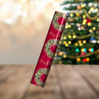 Christmas Wreath Gift Wrap Roll with festive wreath and Merry Christmas design on red background, 4-metre roll in front of holiday tree.