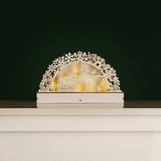 Light Up Wooden Village Christmas Candle Bridge Scene with glowing festive display on mantelpiece.