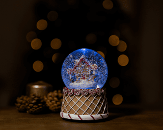 Christmas Gingerbread Snow Globe Musical LED Light with gingerbread scene and LED illumination, perfect holiday decoration.