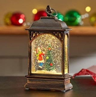 Christmas snow globe tree ornament with LED lantern scene, featuring hand-painted details and festive holiday décor ambiance.
