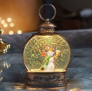 Christmas Snow Globe Ornament with LED lantern and snowman scene, adding festive charm with swirling glitter and warm lights.