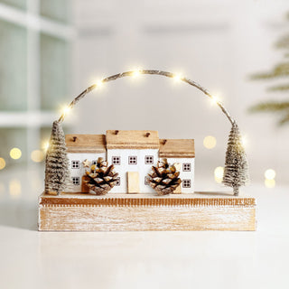 Festive Wooden LED Christmas Village Scene with warm white lights and pine cone details, perfect light-up Xmas decor for any home.