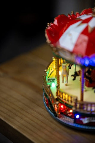 Festive LED Carousel Christmas Scene with intricate details and colorful lights, perfect for holiday decoration and spreading cheer.