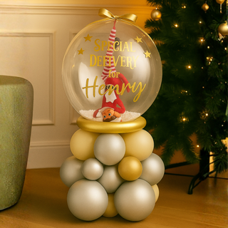 Butter Silver & Gold Luxe Elf Bubble Stack Balloon with festive design next to Christmas tree, featuring gold and silver colors.