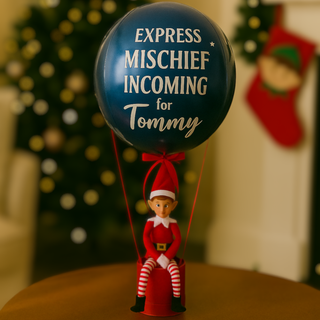 Navy Elf Arrival Balloon with "Express Mischief Incoming for Tommy" message and festive props.
