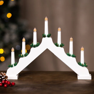 7 Bulb White Wooden Christmas Candle Bridge on a table with festive background.