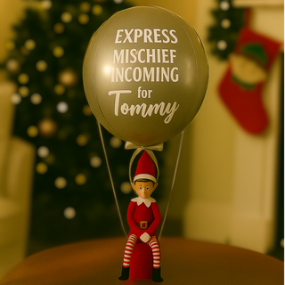Silver Elf Arrival Balloon with festive elf and personalized message against holiday backdrop.