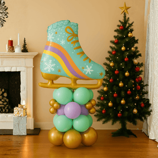 Festive ice skate balloon stack display with Christmas tree and fireplace, perfect for holiday parties and winter sports enthusiasts.